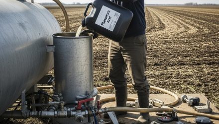 Farmer Pouring Phosphoric Acid at Field